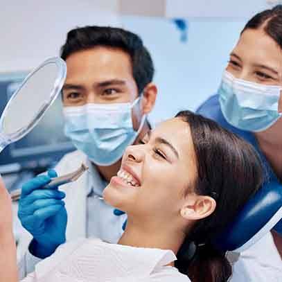 Patient in Garland smiling with friends after cosmetic dental bonding