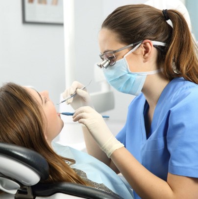 Closeup of dental hygienist cleaning patient's teeth