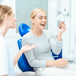 a dental patient admiring her smile