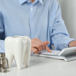 a person calculating their dental finances