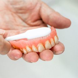 Person using a toothbrush to clean their teeth 