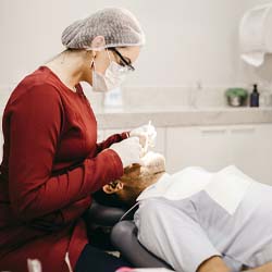 Man in dental chair for dentures in Garland