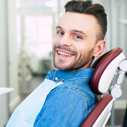 Man in dental chair visiting an emergency dentist in Garland, TX