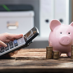 Pocket calculator operated near piggy bank
