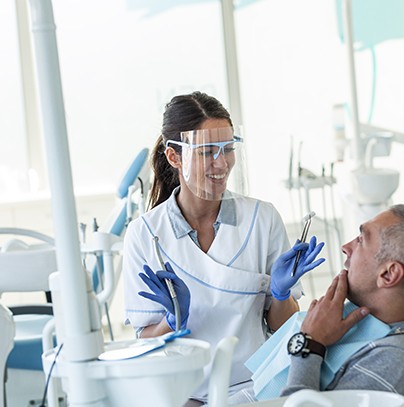 Dentist smiling at patient during exam
