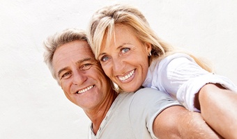 Two older adults, both potential candidates for dental implants