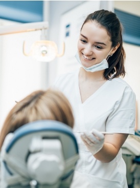 Dental team member smiling at patient during emergency dentistry visit