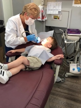 Garland dentist treating young dental patient