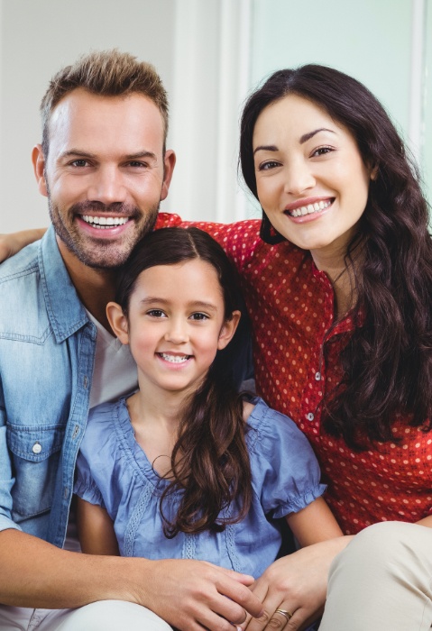 Mother father and child smiling after family dentistry visit