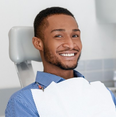 Man smiling during dental checkup and teeth cleaning visit