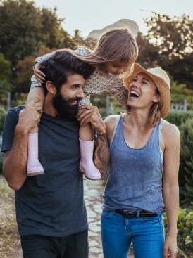 Parents and child smiling after family dentistry