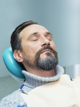 Man relaxing during sedation dentistry visit