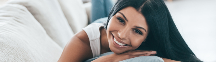Smiling woman laying on couch