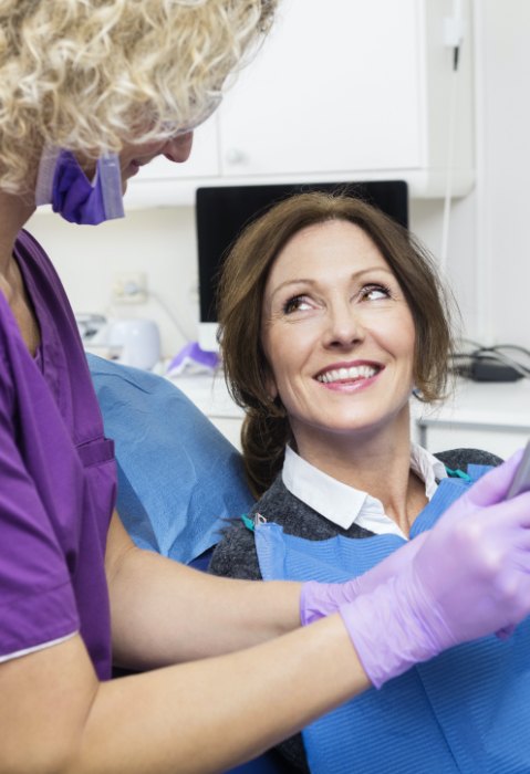 Woman  in dental chair smiling at dentist