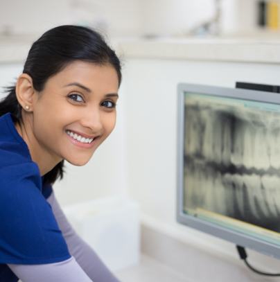 Dental team member looking at digital x-rays