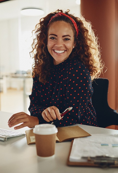 Woman smiling at desk in office