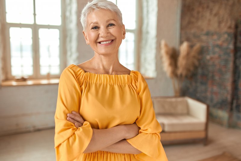 woman smiling with implant dentures in Garland