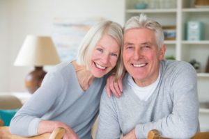 smiling senior man and woman with All-on-4 dental implants  