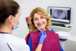 Older woman in dentist's chair.